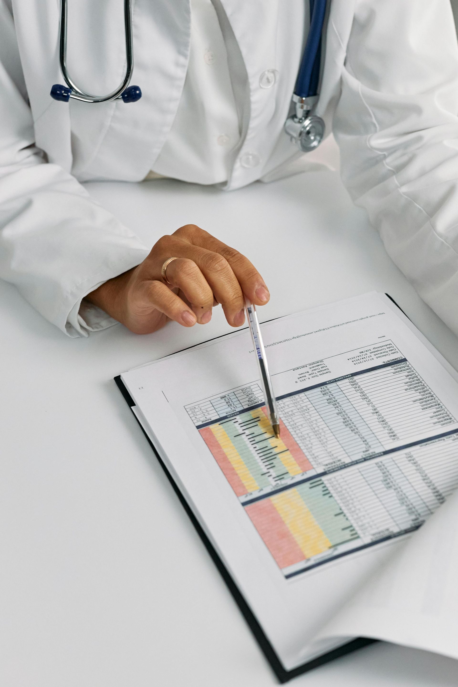 Doctor reviewing pre-employment medical assessment results with stethoscope and clipboard