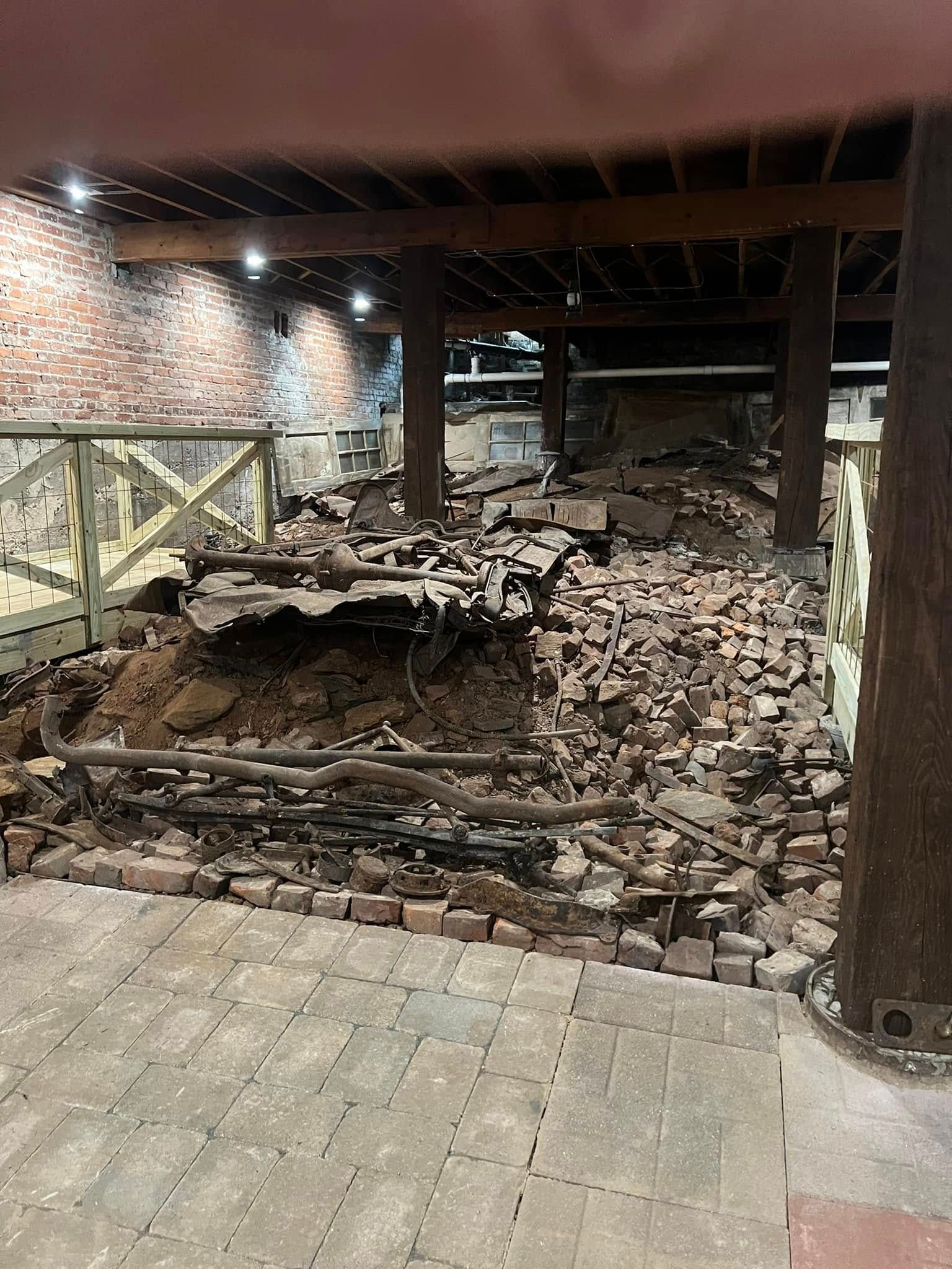 A room with a lot of bricks on the floor and walls.
