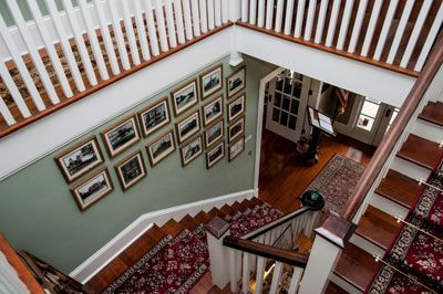 An aerial view of a staircase with pictures on the wall.