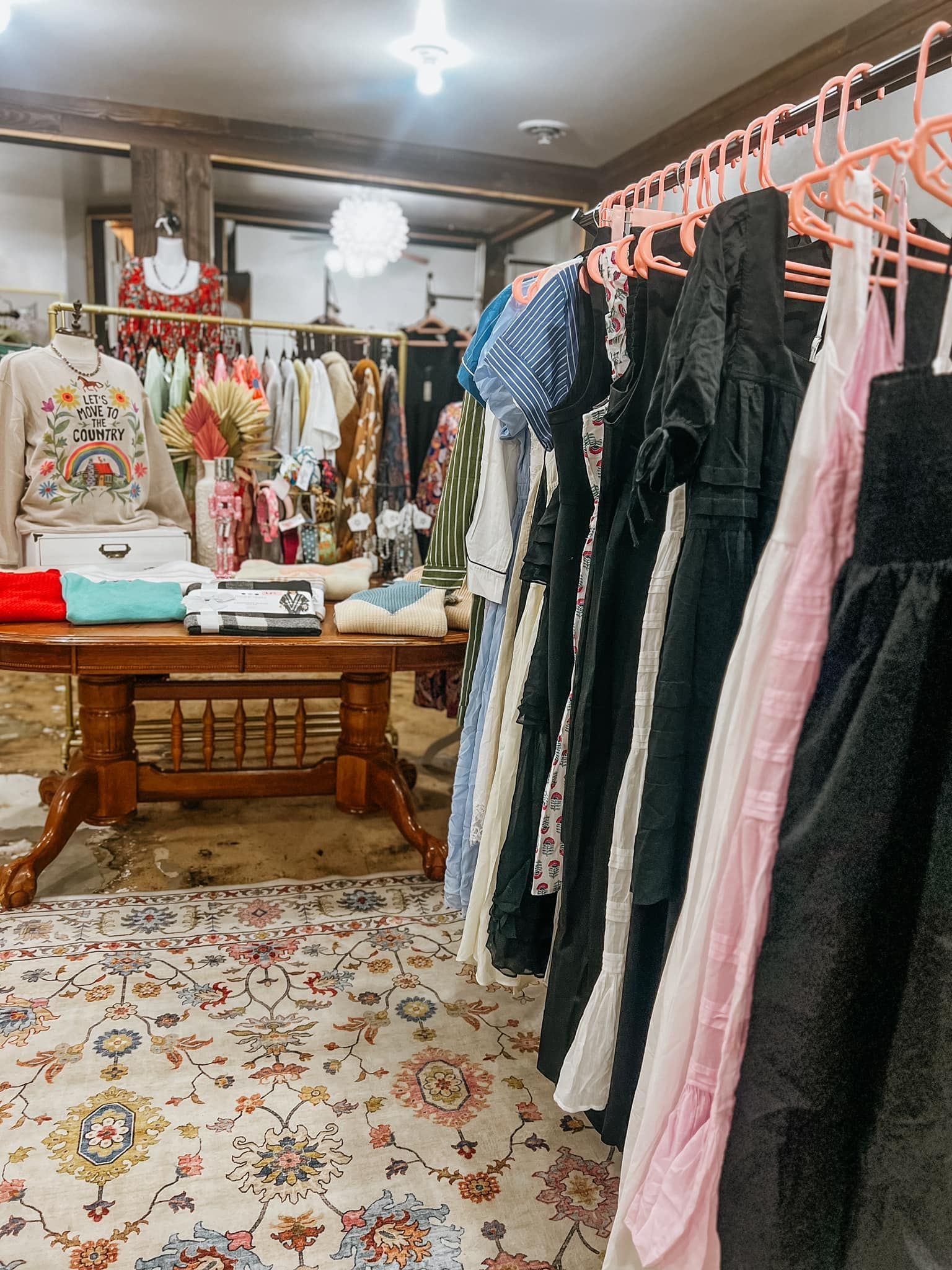 A row of clothes hanging on a rack in a store.