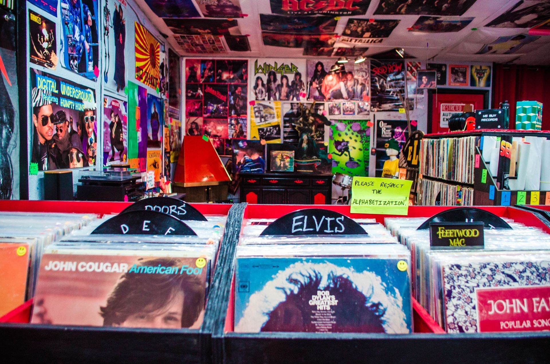 A display of elvis and john cougar records in a record store