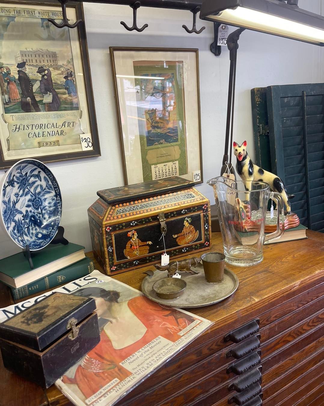A table with a lot of antique items on it