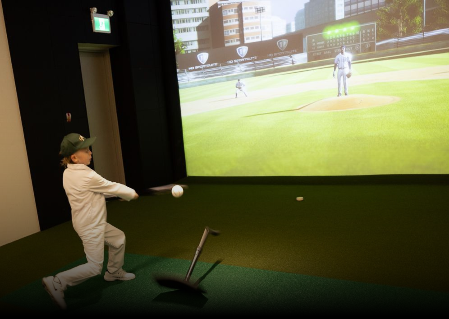 A young boy is playing a virtual baseball