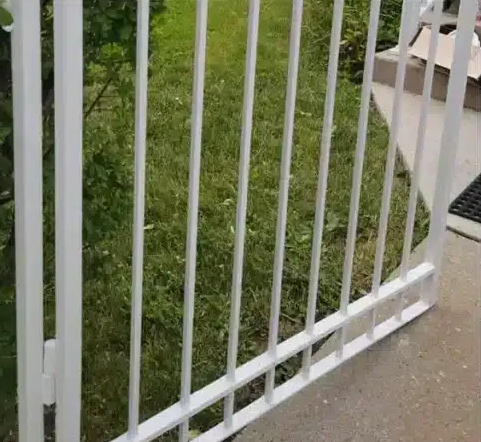 Wooden privacy fence with vertical slats and a small potted plant at the bottom right.