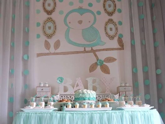 Baby shower dessert table with bird-themed decorations in mint and gold colors.