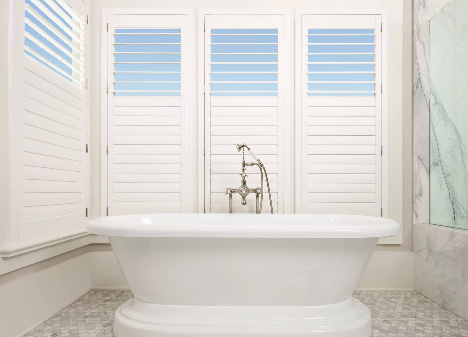 Hunter Douglas Palm Beach™ Polysatin™ Vinyl Shutters in a bathroom near Kalaheo, Hawaii.