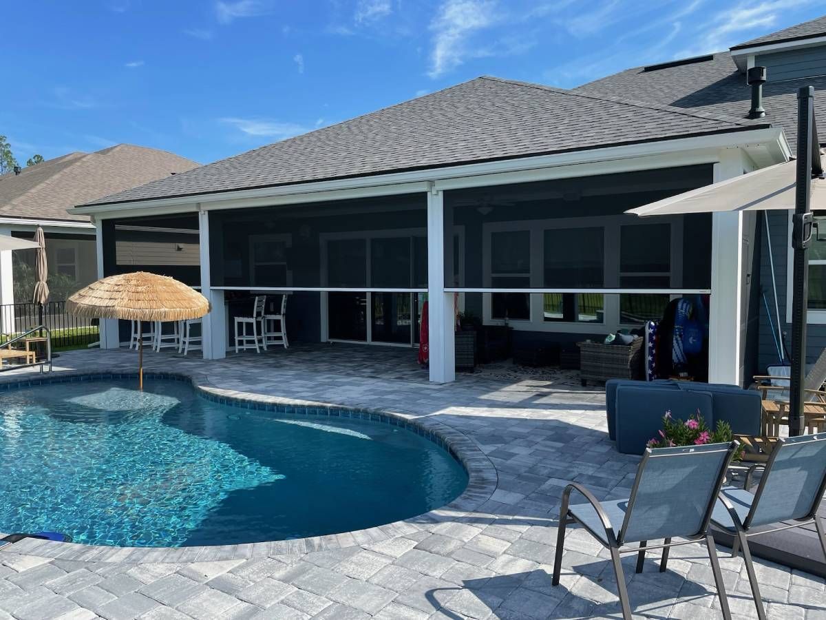 Lanai with retractable Fenetex hurricane shades lowered halfway.