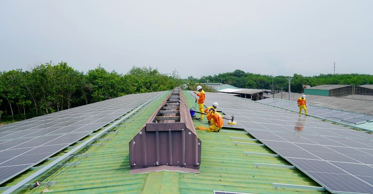 Dracut Solar installing solar panels on a commercial building in Dracut, MA.
