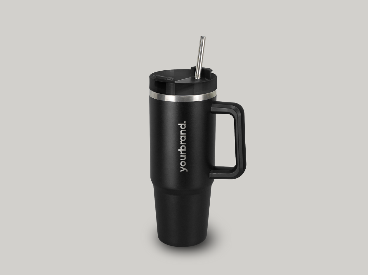 Black stainless steel travel mug with handle and straw on a gray background