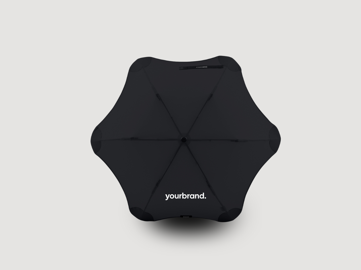 Black geometric foldable stool or ottoman on a light gray background