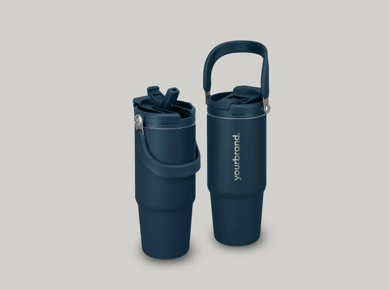 Two dark blue travel mugs, one open with a lid and one with a handle, on a light background