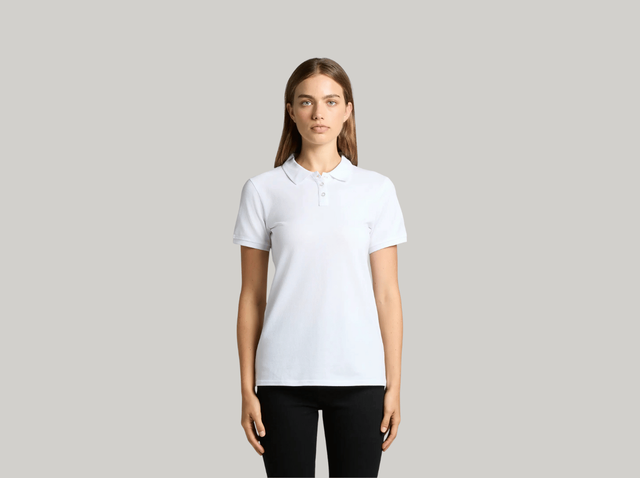 Person wearing a white polo shirt and black pants against a gray background