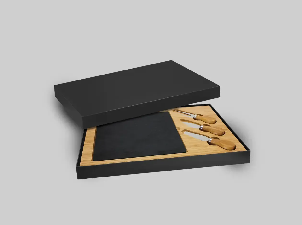 Open black presentation box with wooden insert and black rectangular item inside