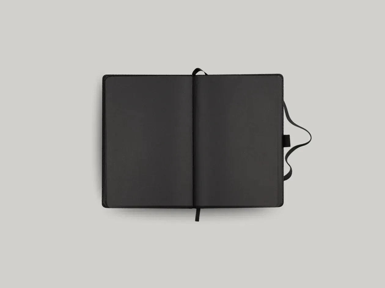 Black notebook or planner with “yourbrand.” logo on the cover, shown closed on a white background