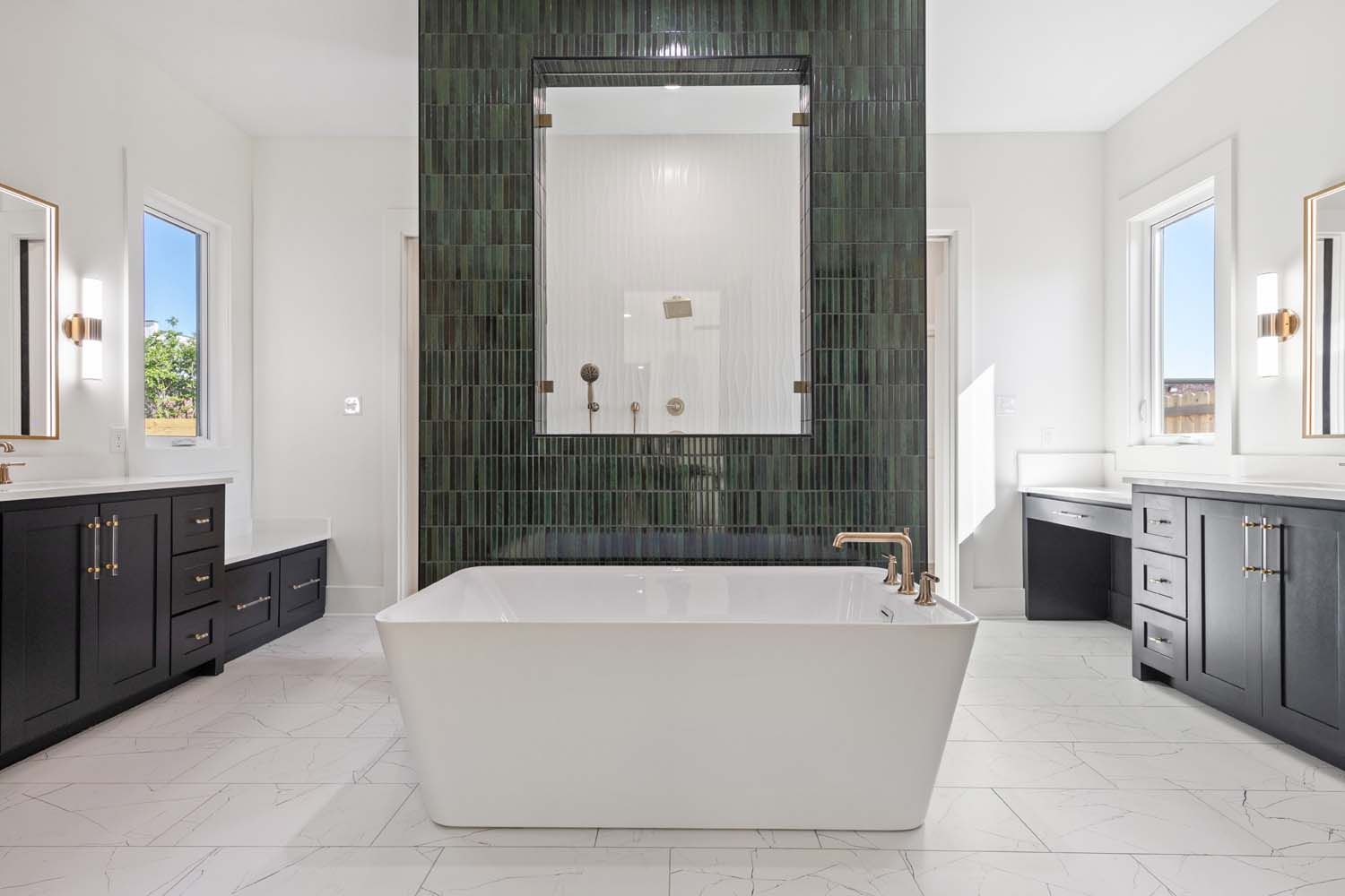 Spacious bathroom with white tile floor, a large tub, dark green tile wall, and dark cabinets.