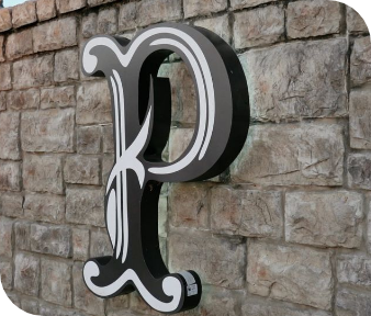 Black-and-white letter P sign mounted on a stone wall