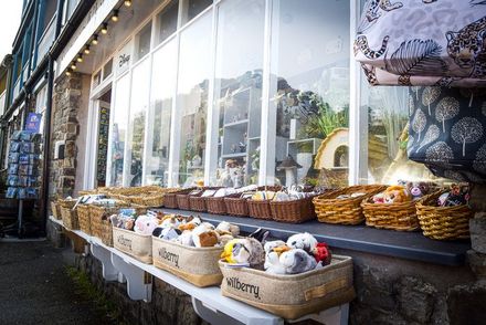 Baskets containing toys in front of gift shop.