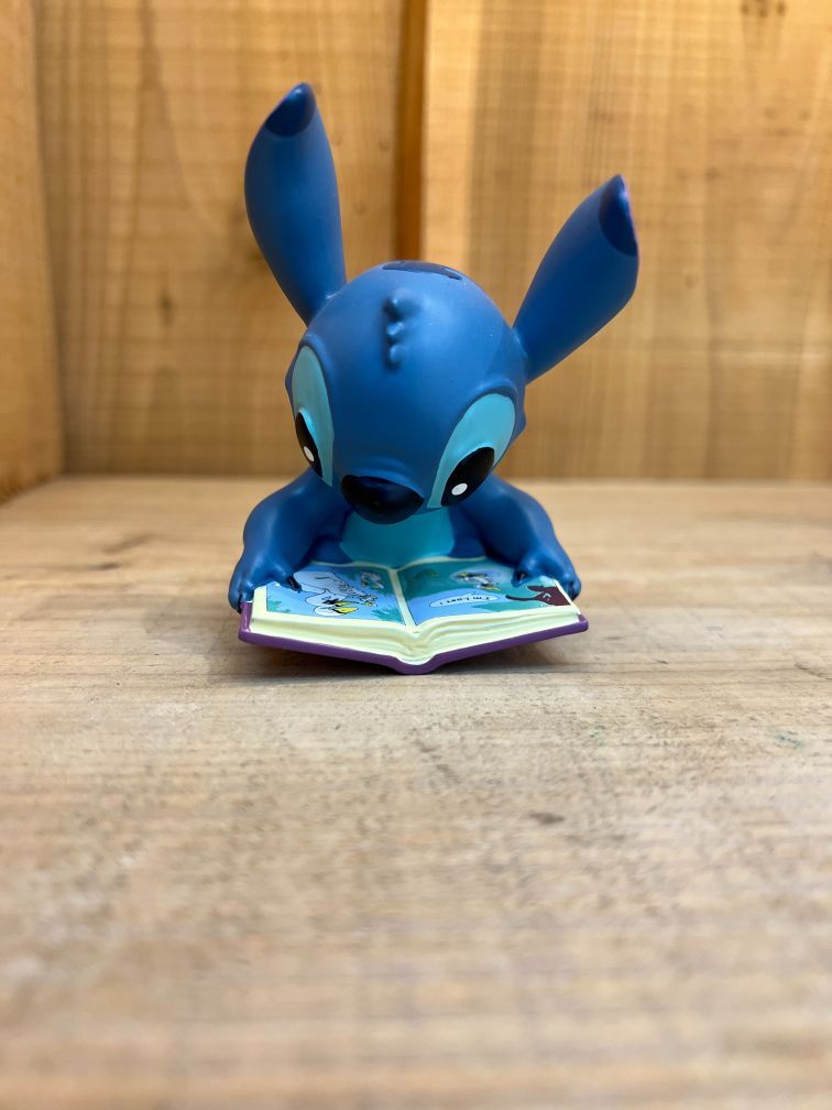 Stitch with a book, figurine.