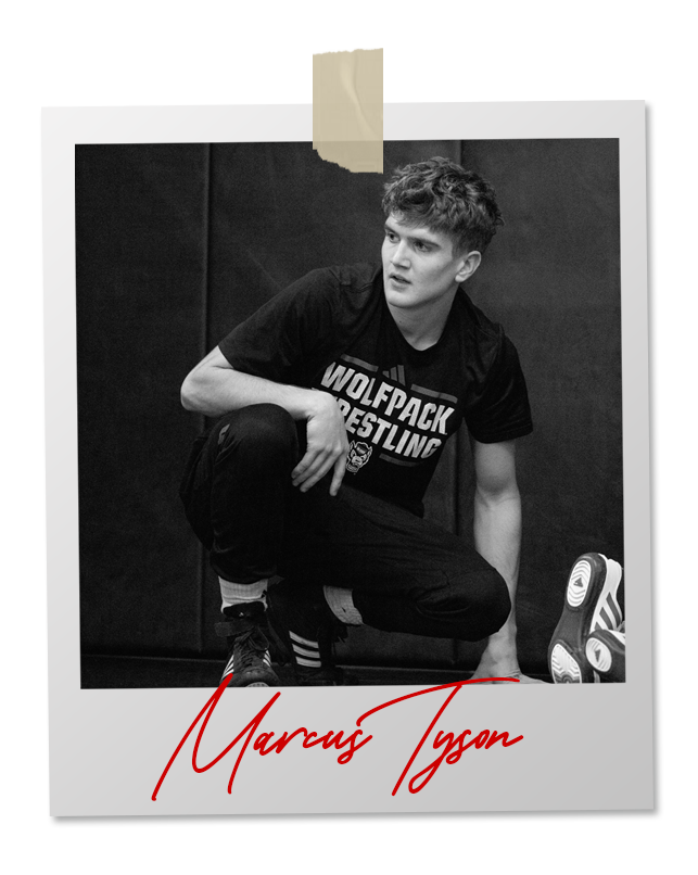 A black and white photo of a wrestler in an 