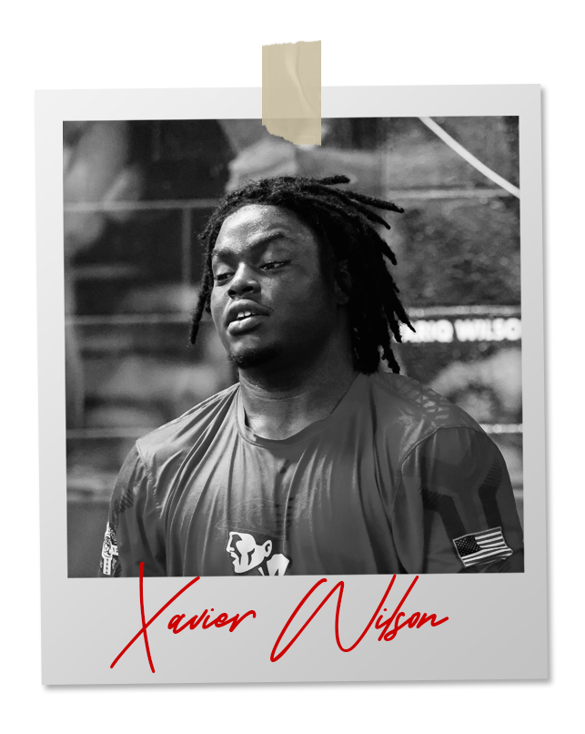 A black and white photo of a wrestler in an 