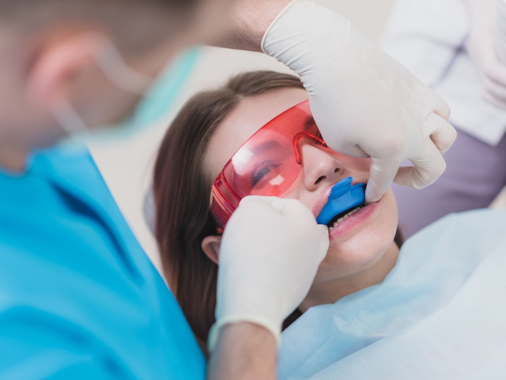 A young girl getting a fluoride treatment at the dentist