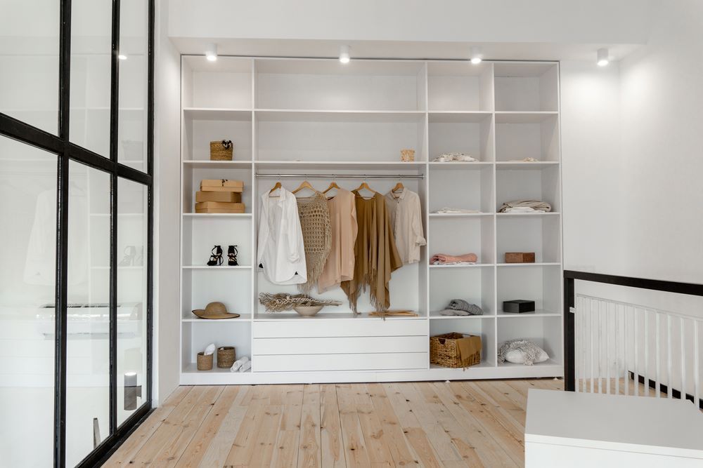 A Walk in Closet With Lots of Shelves and Clothes Hanging on Them — Wardrobe World In Paget, QLD
