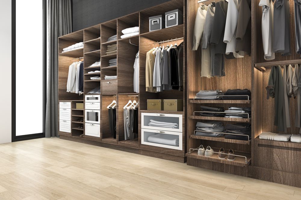 A Walk in Closet Filled With Lots of Clothes and a Large Window — Wardrobe World In Paget, QLD