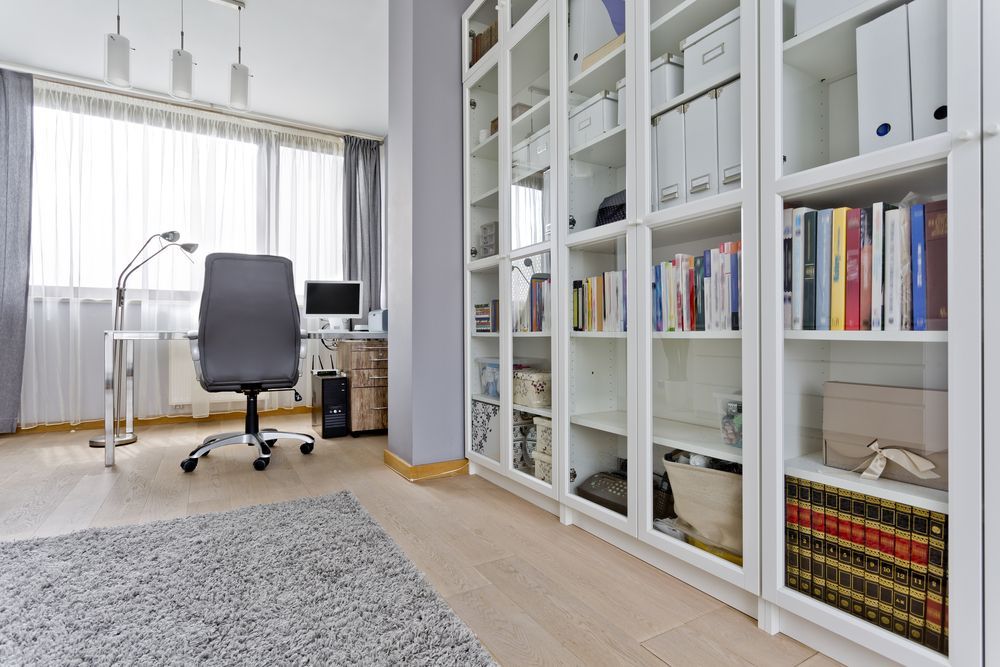 A Home Office With a Desk , Chair , Computer and Shelves Filled With Books — Wardrobe World In Paget, QLD