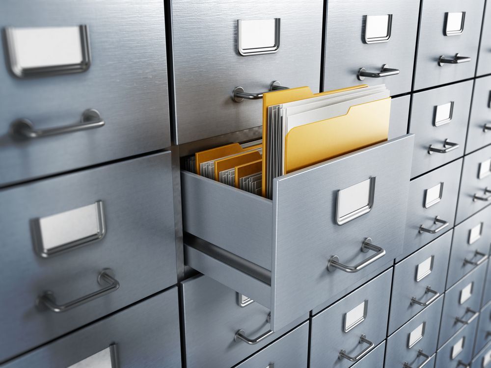 A Row of Filing Cabinets With One Drawer Open and a Yellow Folder in It — Wardrobe World In Paget, QLD