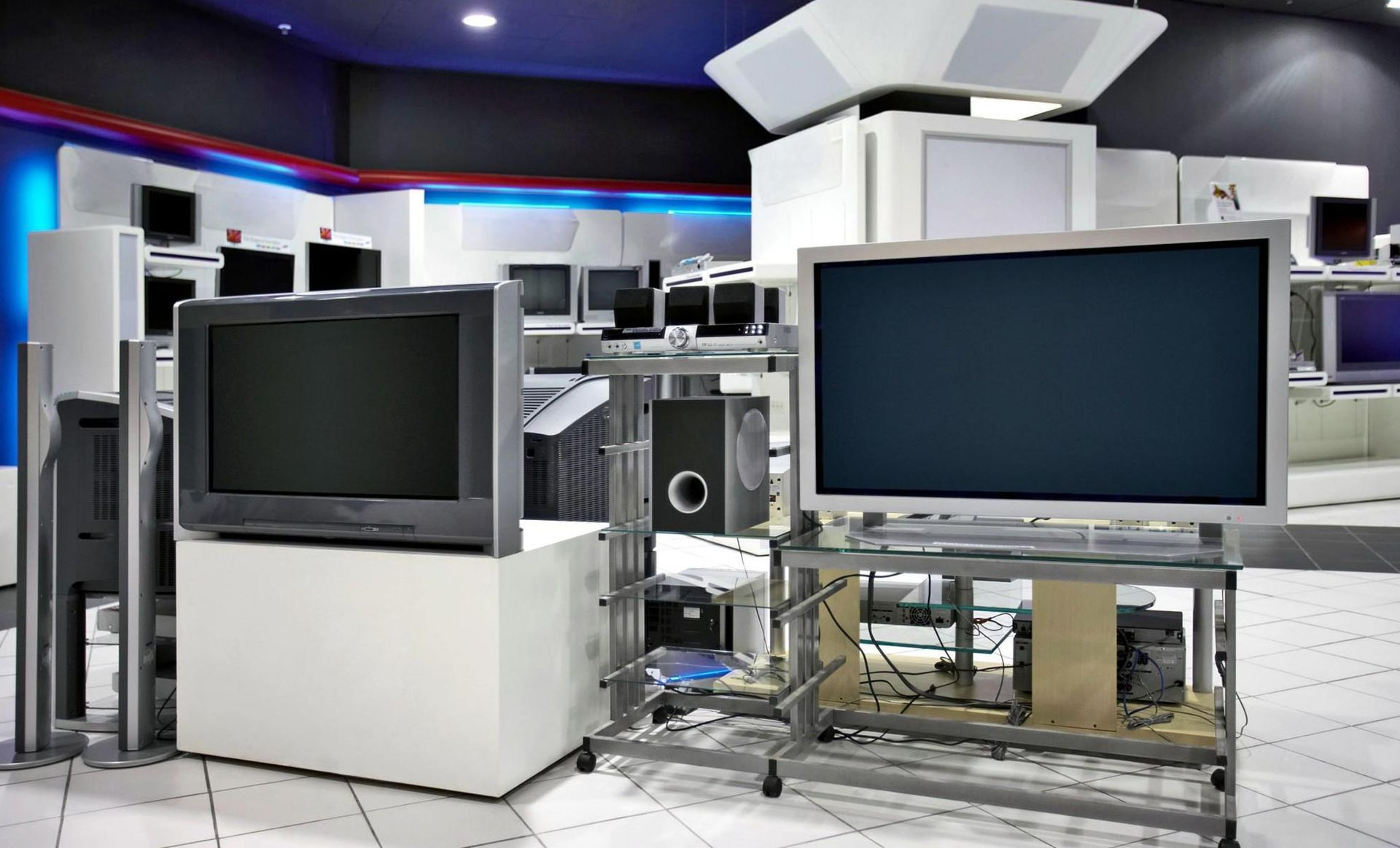 A bunch of televisions are on display in a room