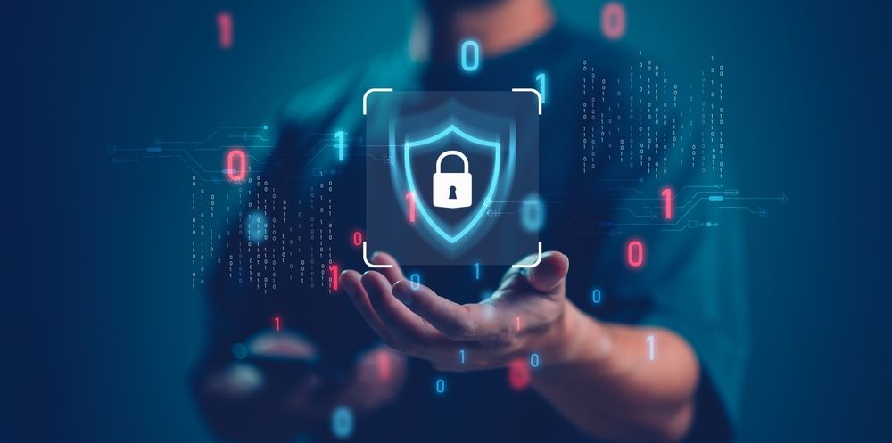Hands holding a glowing shield lock icon over a blue digital network background