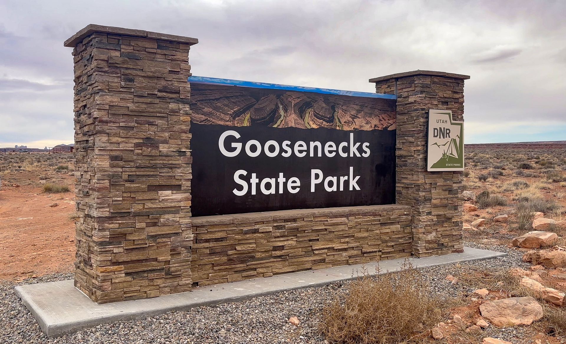 A sign that says goosenecks state park on it