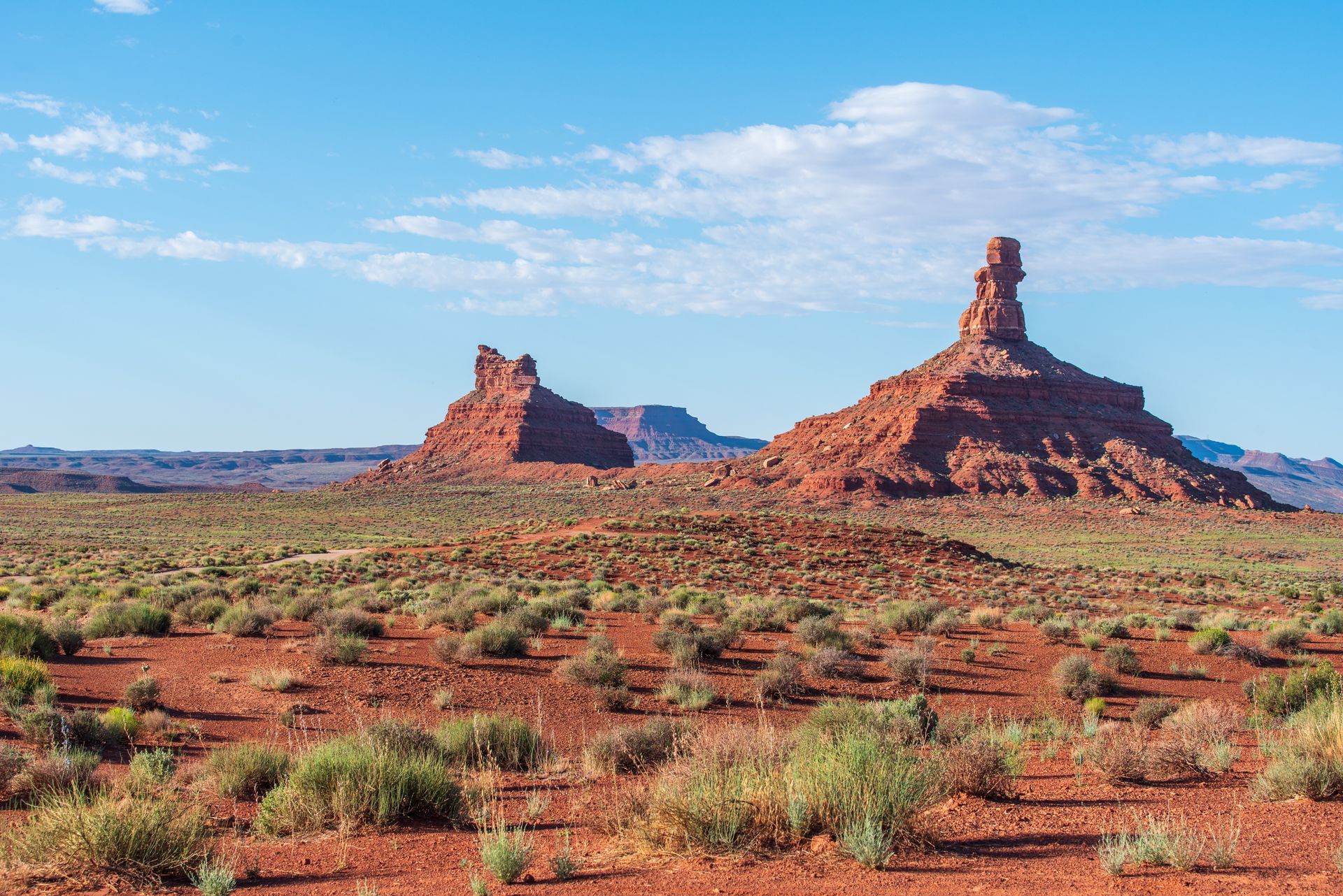There are two rock formations in the middle of the desert.