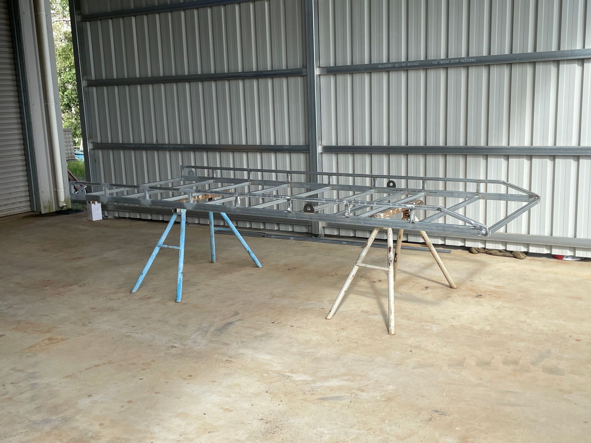 Black Metal Frame on Cardboard on Grass — Australian Mobile Welding Pty Ltd in Atherton, QLD