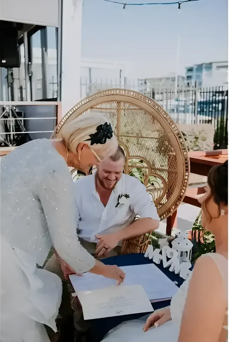 A Bride And Groom Are Signing A Document At A Wedding Ceremony — Carolynn Farmer-Celebrant In Emu Park, QLD