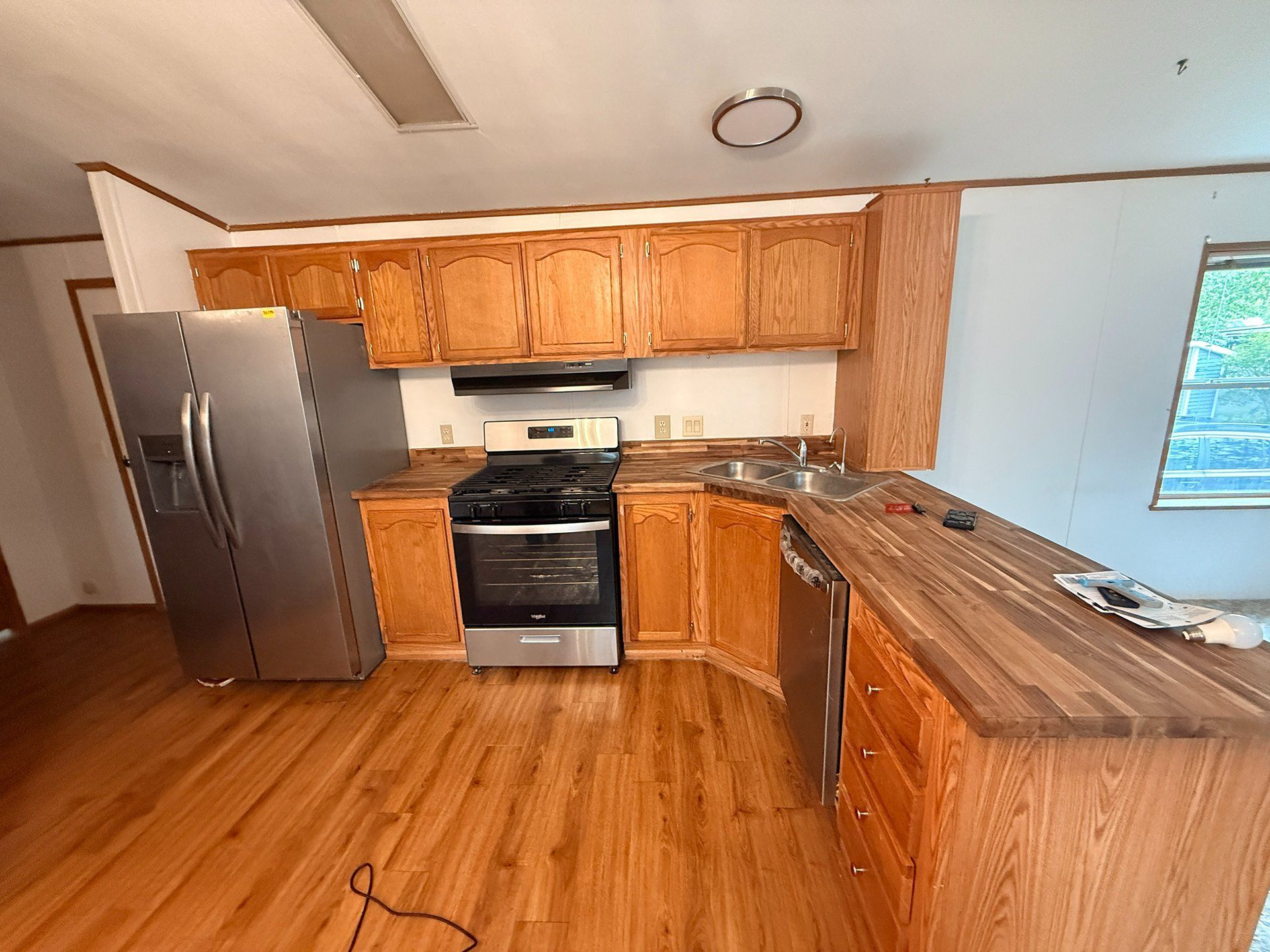 Modern kitchen with wood cabinets, stainless steel appliances, and a large island counter