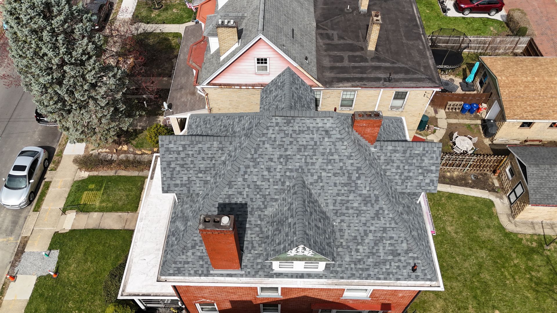 Gray asphalt shingle roof with a dark ridge cap and a small vent.