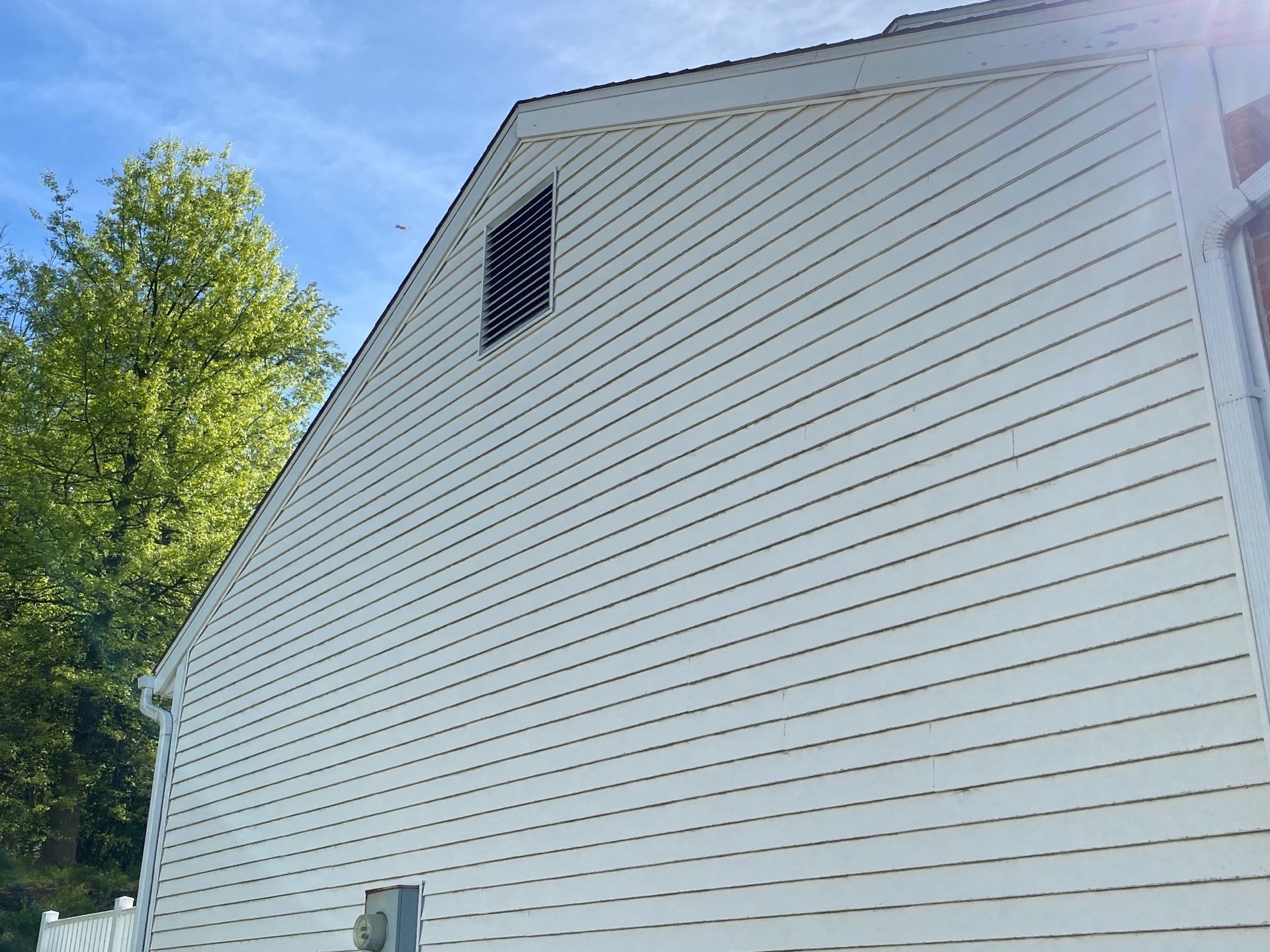 Asphalt shingle roof with varied gray and tan tones; black trim.