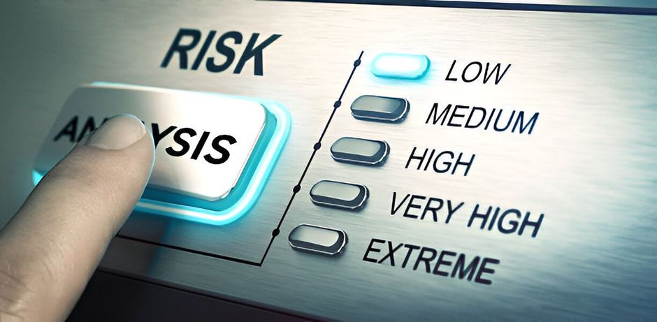 A person is pressing a button that says risk on it.