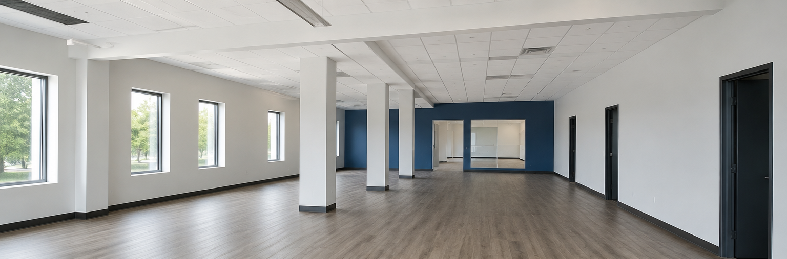 Empty modern office interior with white walls, wood floors, windows, and black doorways