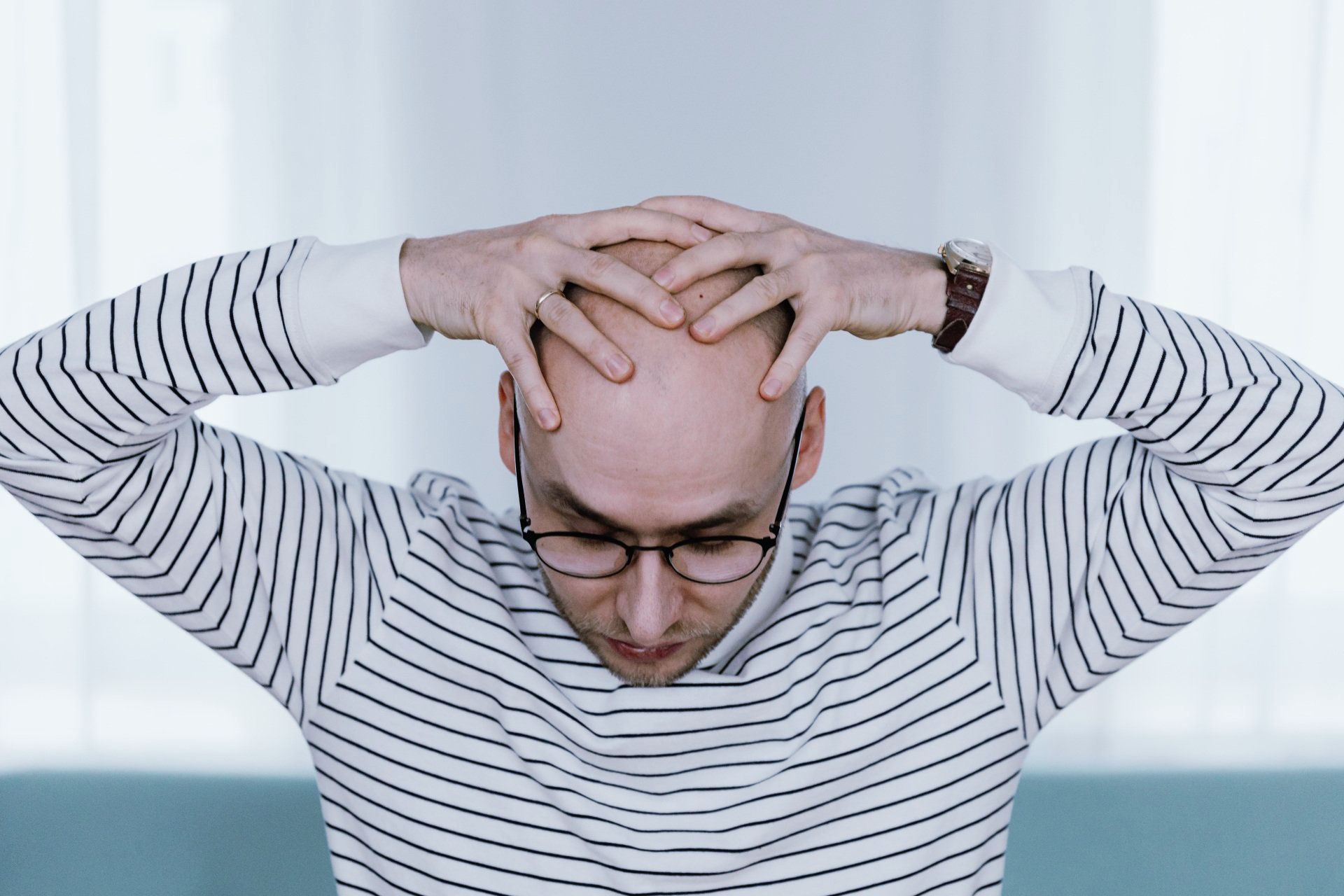 Man with Hands on Head
