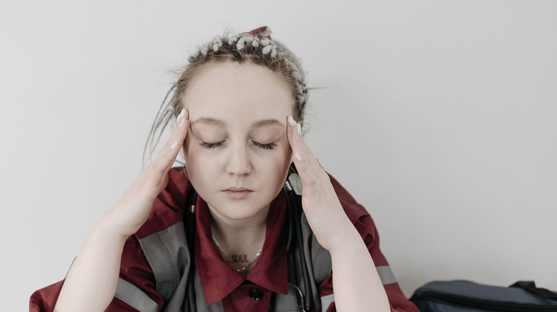 Woman Sitting and Suffering From a Headache