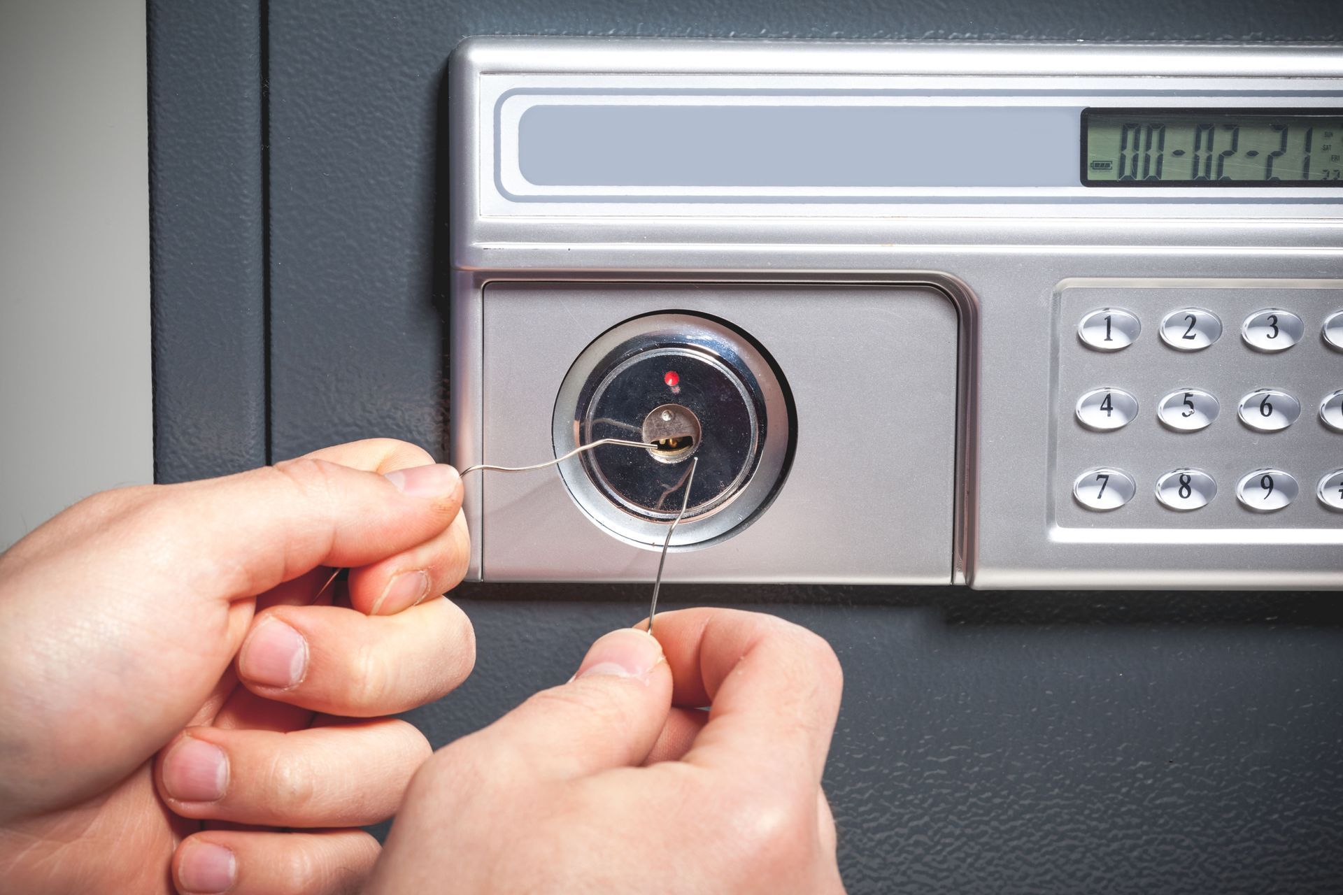 A person is opening a safe with a key.