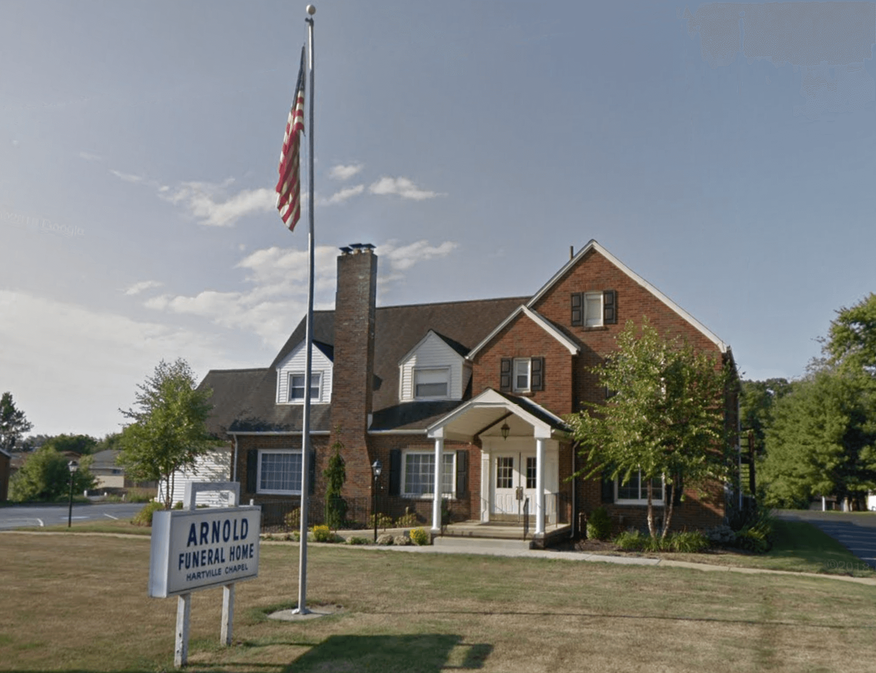 A large brick house with a sign that says apollo funeral home