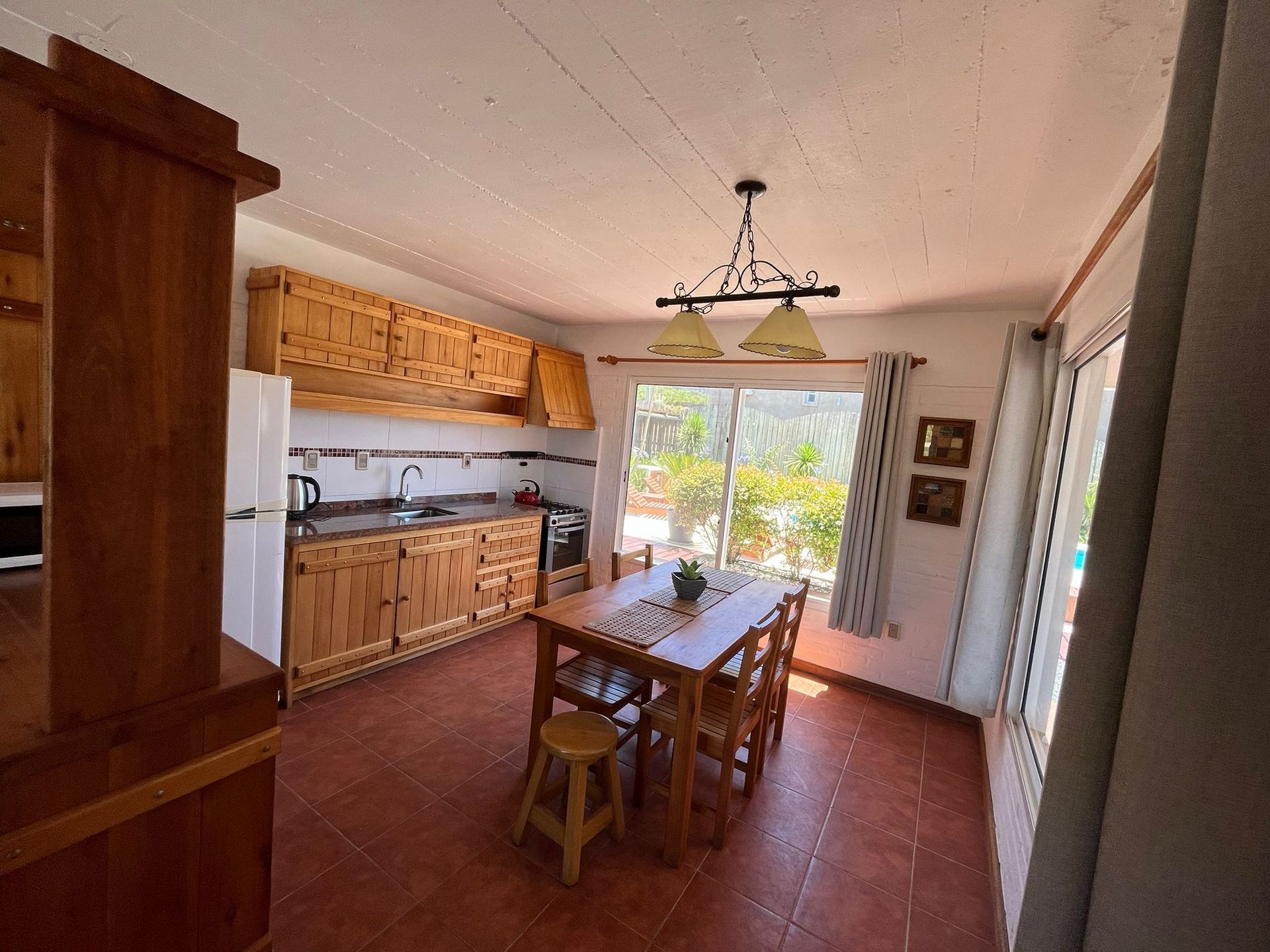 A kitchen with a table and chairs in it