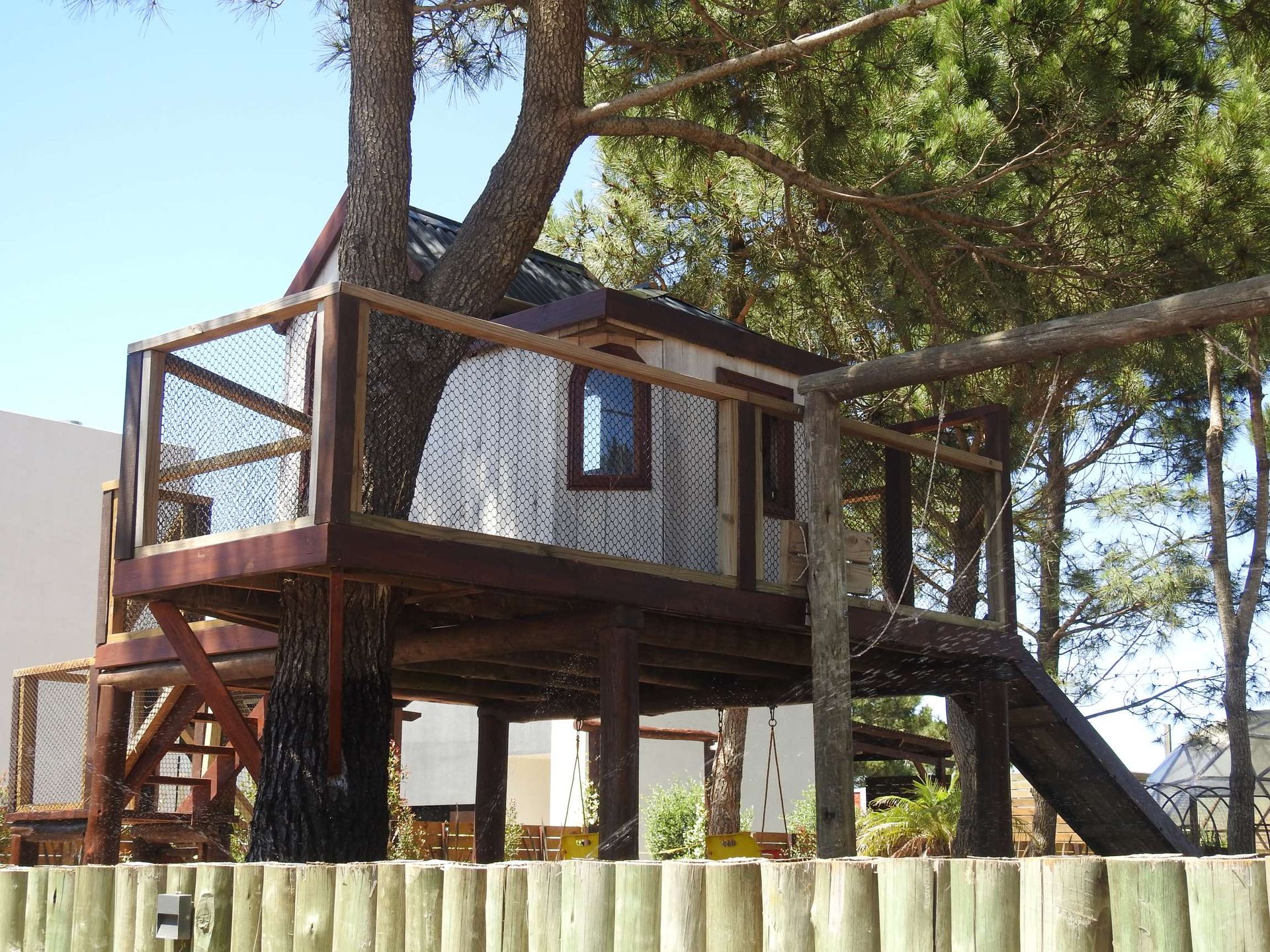 A tree house with a slide attached to it
