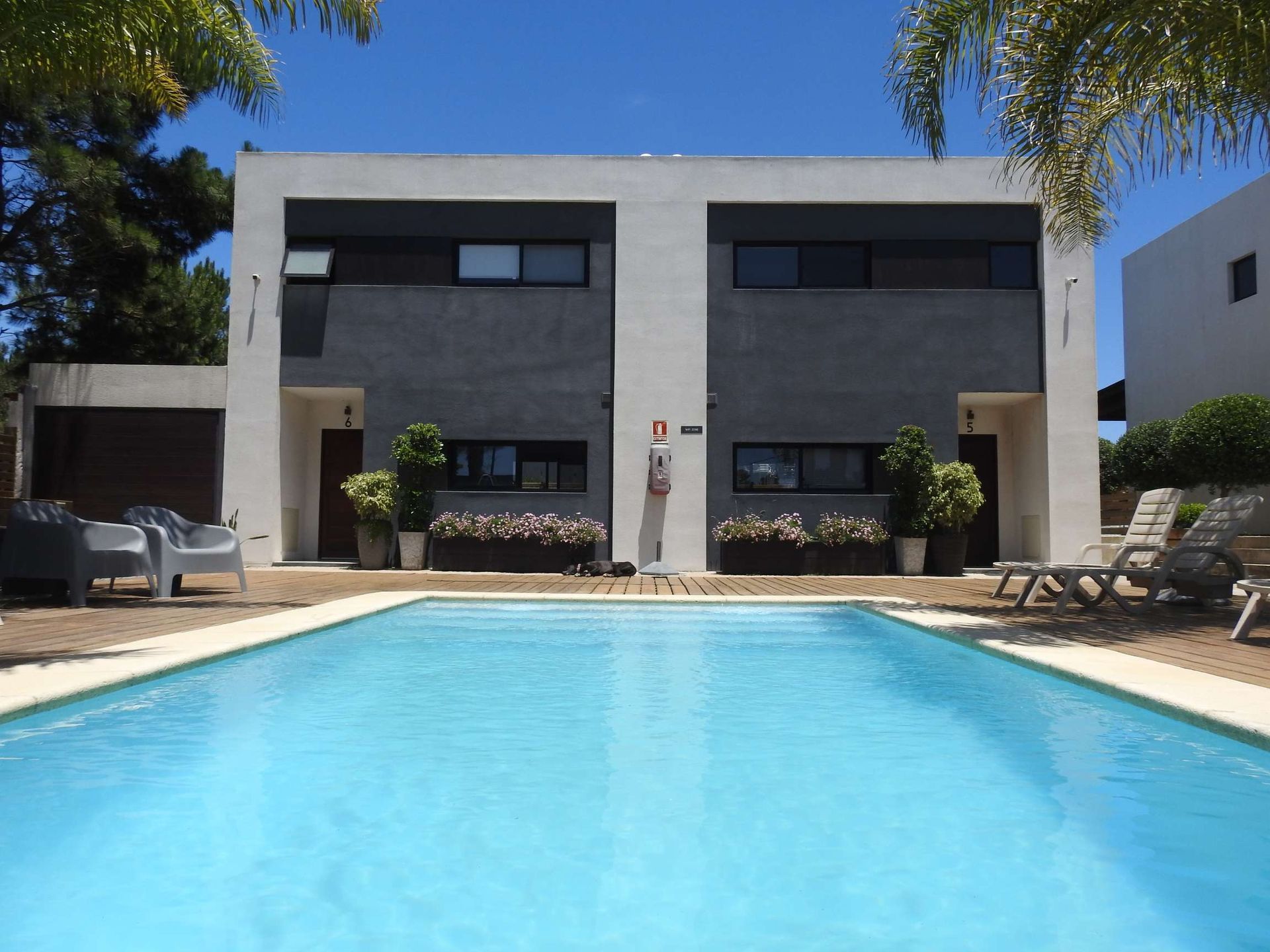 A large house with a swimming pool in front of it