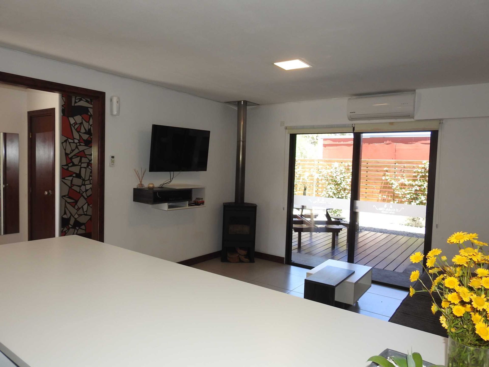 A living room with a flat screen tv and a fireplace