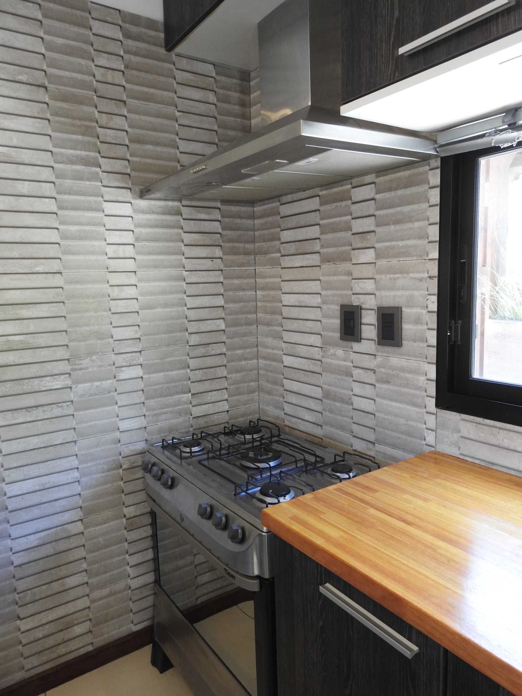 A kitchen with a stove top oven and a wooden counter top