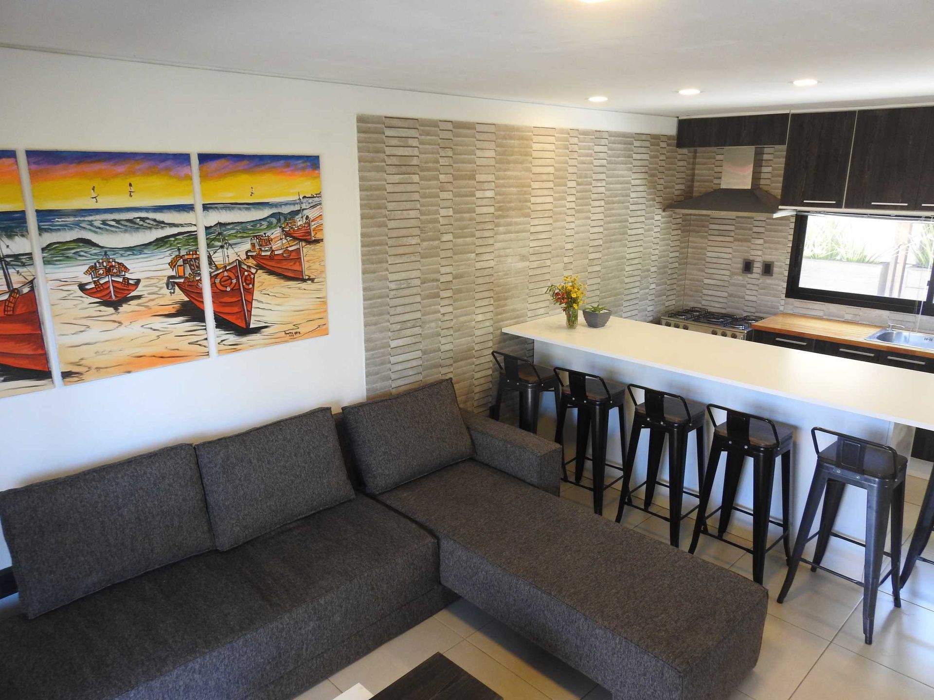 A living room with a couch and a painting on the wall